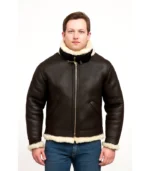 Front view of a man wearing a dark brown B3 shearling bomber jacket featuring a thick cream wool lining, double-buckle throat latch, and waist adjustment straps.