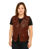 A women’s Rhonda maroon leather biker vest featuring an asymmetrical zip front, notched lapels with silver snaps, and a tailored sleeveless fit.
