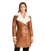 A woman wearing a premium women's brown shearling coat with a supple leather exterior and a thick, cream-colored wool lining.