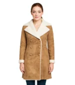 Give The Image Alt Text, Image caption and The Image Desc A woman wearing a weathered, distressed brown leather coat with a thick, cream-colored genuine sheepskin lining.