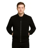 Close-up of a men’s premium black suede bomber jacket featuring a ribbed-knit collar, silver-tone zipper, and two side welt pockets.