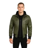 Men’s olive green leather bomber jacket featuring a grey detachable fabric hood, silver zipper closure, and ribbed-knit cuffs.