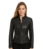A women’s black cafe racer leather jacket featuring a minimalist snap-tab collar, a central front zipper, and a slim-fit silhouette.