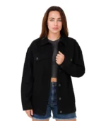 A video showcasing a woman wearing an oversized black denim jacket with a relaxed drop-shoulder design and a faded charcoal wash.