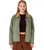 A plus-size woman modeling a khaki green denim jacket featuring a zip-up front and a structured spread collar.