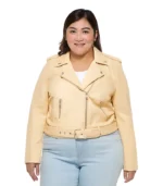 A smiling woman wearing a structured plus-size motorcycle jacket featuring an asymmetrical zip and wide waist belt.