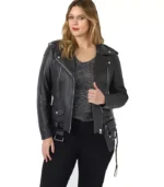 Front view of a woman wearing a stylish black plus-size leather biker jacket with silver zippers and waist belt.