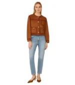 A women’s brown suede jacket with a velvety matte finish, featuring a tailored fit and classic metallic hardware.