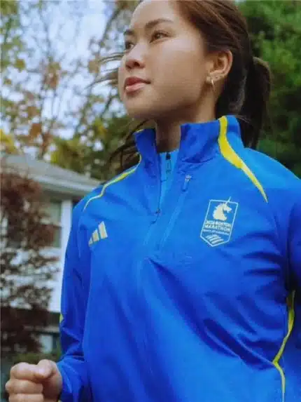 Boston Marathon Jacket 2026 in celebration blue with zip front, collar, and side pockets.