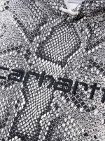 Front close‑up view highlighting the snake print and hood on this statement pullover