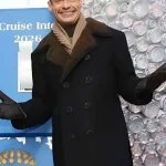 Full view of Ryan Seacrest 2026 black peacoat showing classic peacoat shape and clean winter style