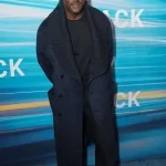 Idris Elba navy blue wool coat showing long overcoat style, clean lapels and winter-ready fit