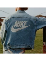 Front view of Levis X Nike blue denim trucker jacket with branding