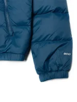 Closeup view of women’s Hydrenalite blue puffer jacket showing zipper detail, stitching, and smooth outer finish.