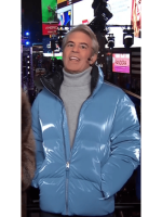 Andy Cohen blue puffer jacket with a half-open zipper look.