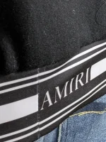 Amiri logo patch varsity jacket close up view of material and stitching