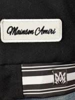 Amiri logo patch varsity jacket close up view of material and stitching